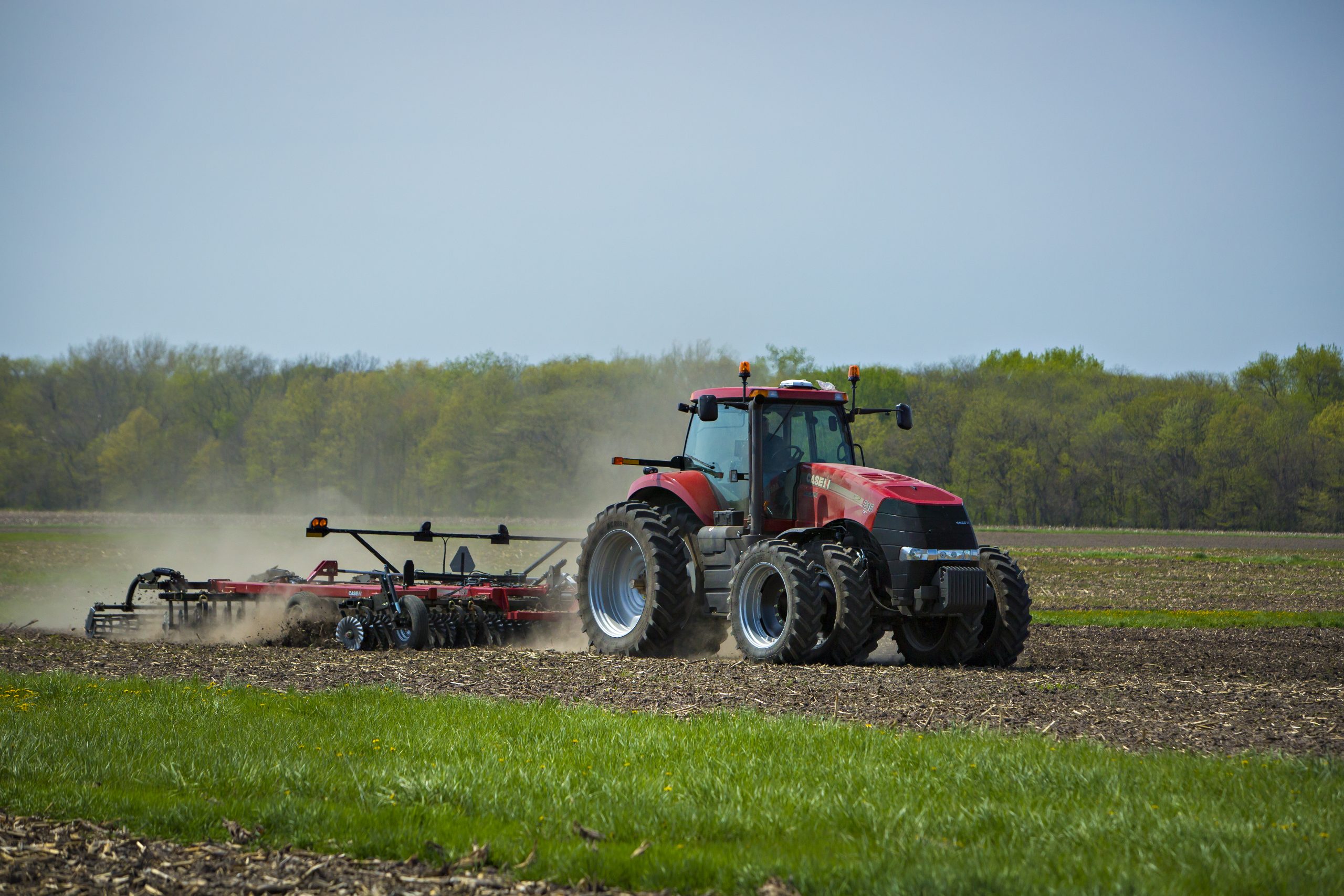 Tractor tilling soil in field